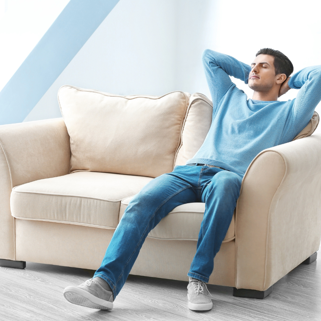 Man relaxing comfortably indoors, showing the impact of proper good insulation in winter.