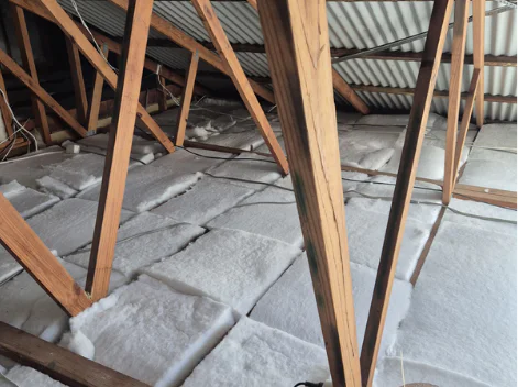a wooden beams with white foam on the floor